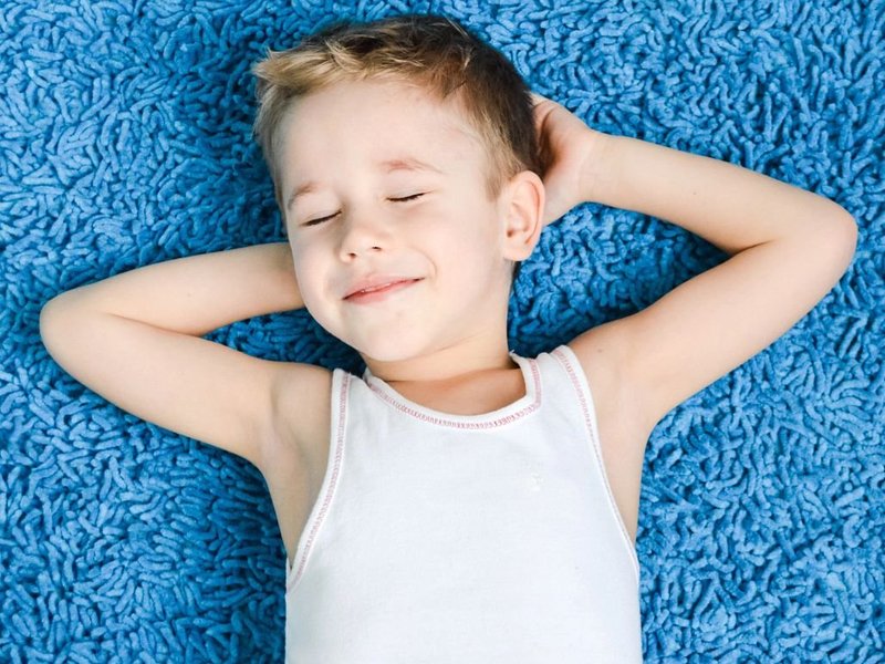 child on blue carpet